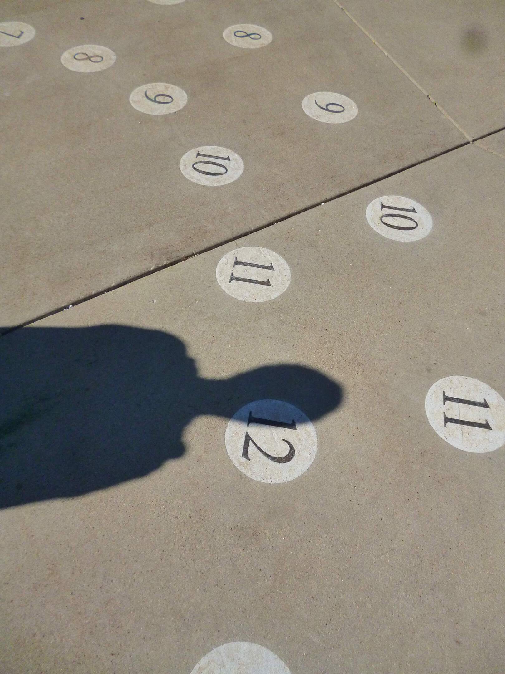 David's shadow on the ground next to a number 12.